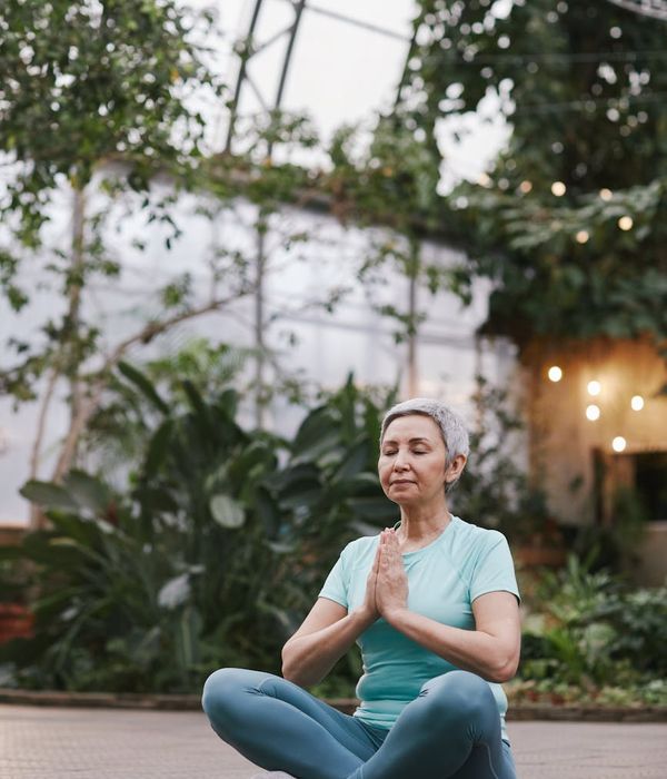 Woman in a calm and focused yoga pose, embodying body harmony.